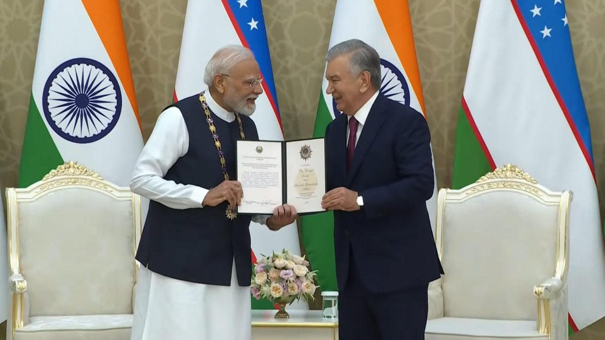 Uzbekistan President Shavkat Mirziyoyev presents PM Narendra Modi with the Oliy Darajali Dostlik Order